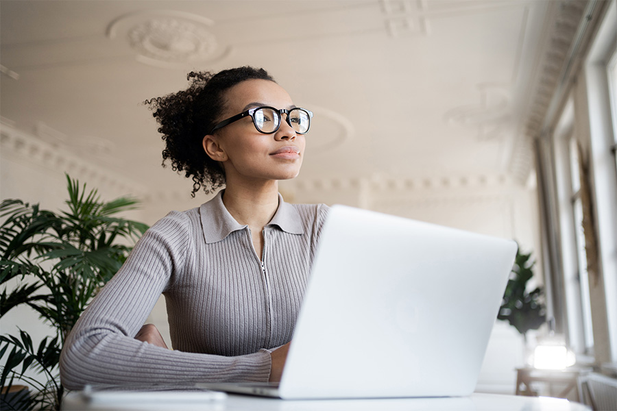 A woman working on a laptop.